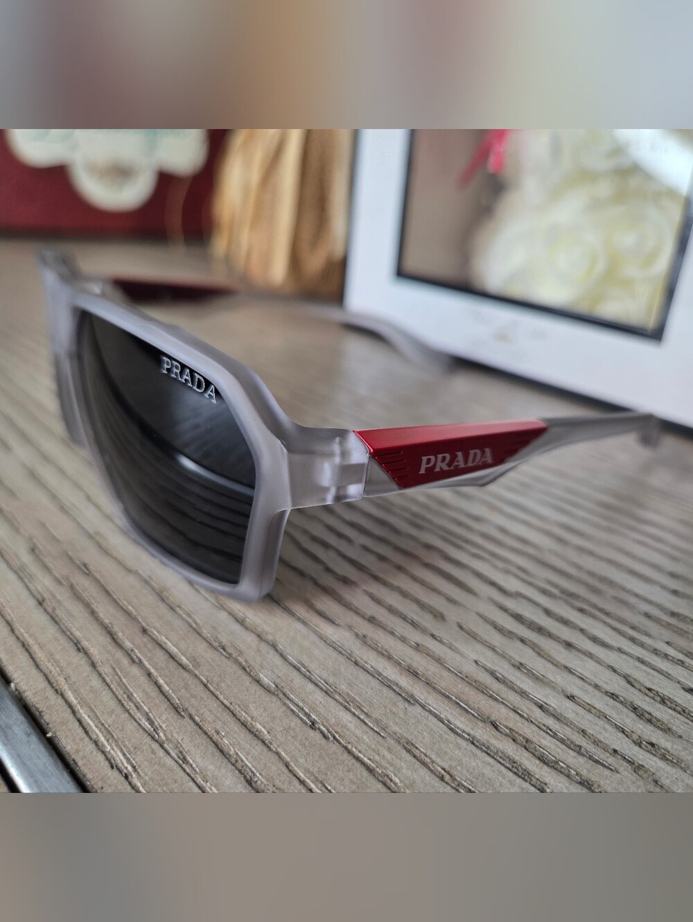 Prada Men’s Matte Clear Frame Sunglasses with Red Temple Accents